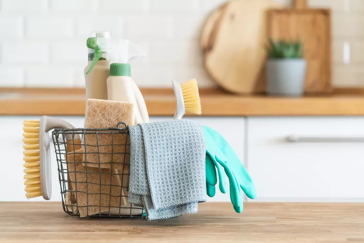 Hand in glove wiping a clean kitchen surface